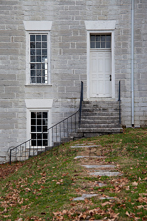 Pathway leading to antique white door.