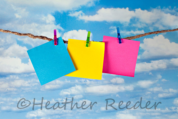 Three blank notes on clothesline outdoors