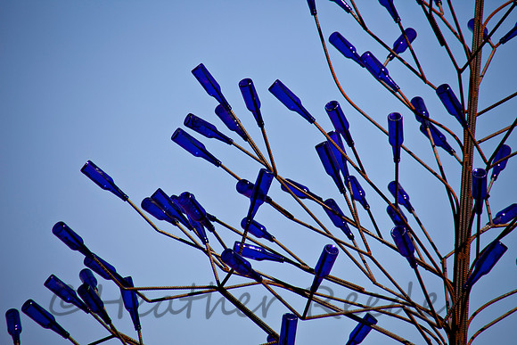 Unique artist sculpture with gorgeous cobalt blue bottles and ironwork.