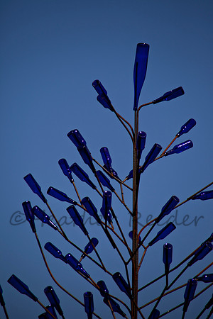 Unique artist sculpture with gorgeous cobalt blue bottles and ironwork.