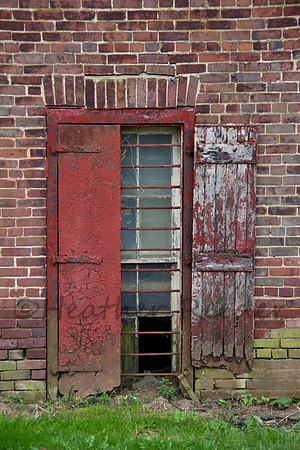 Rectangular windown on aging, rustic brick wall.