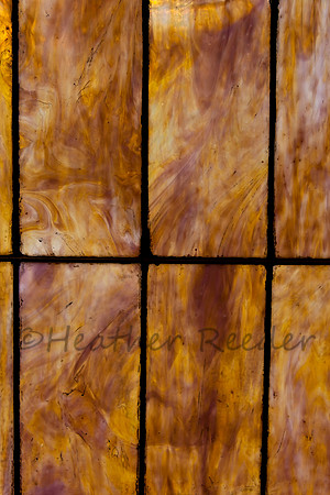 Close up of neutral colored stained glass window.