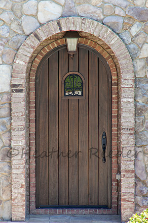 Rock and stone entryway with wooden door.