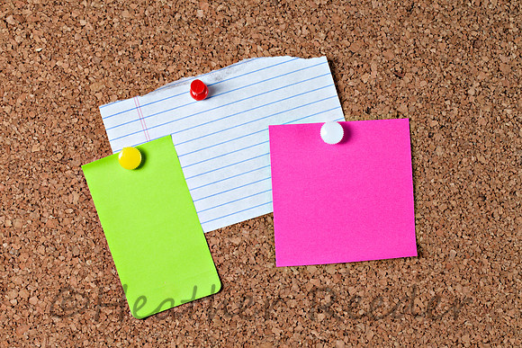 Three colorful blank notes on corkboard