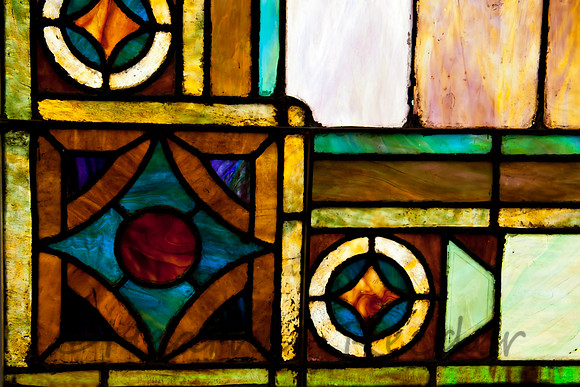 Mulit-colored stained glass window pane.