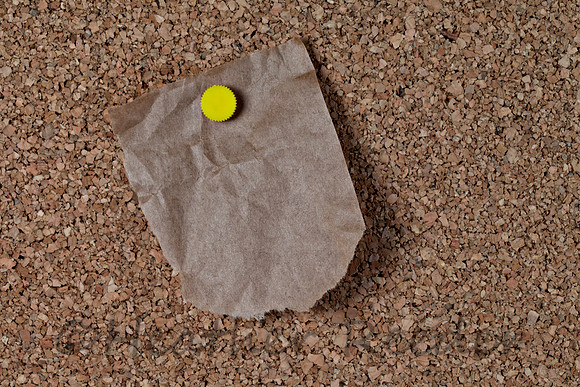 Torn grocery bag blank note pinned to corkboard