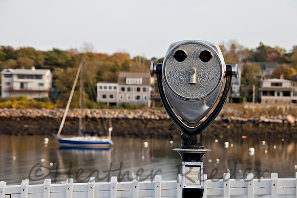 Telescope overlooking picturesque waterway.