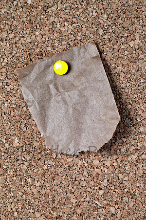 Torn grocery bag blank note pinned to corkboard
