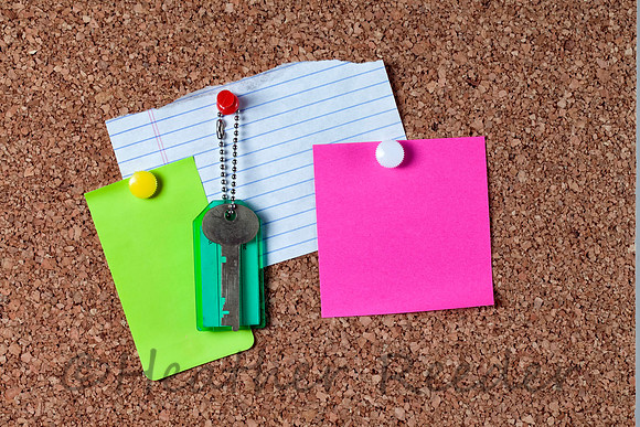 Three colorful blank notes on corkboard